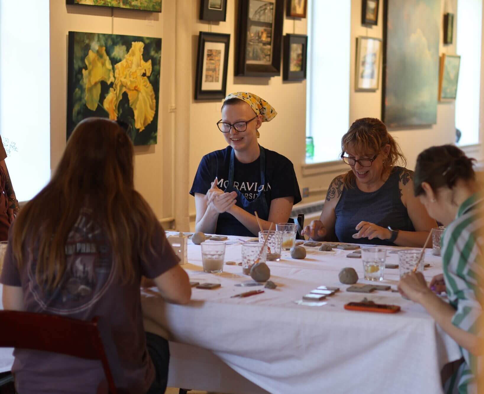 A group of women making hand crafted pottery at an artisan class during the Maker's Retreat in Bethlehem
