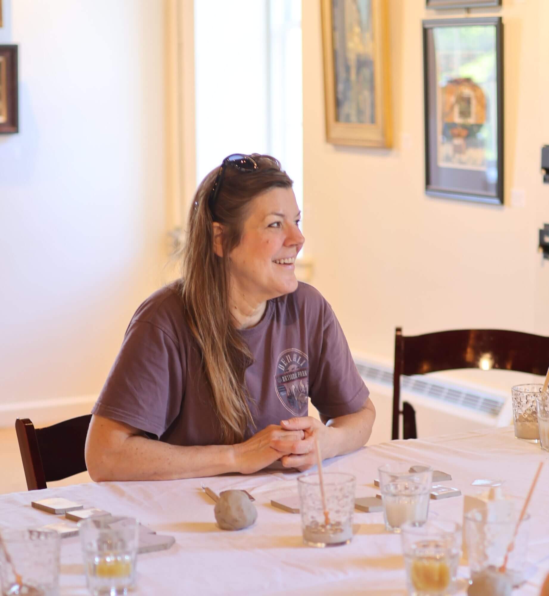 An artisan pottery class participant smiles before beginning an artisan project during the Bethlehem Museums & Sites Maker's Retreat Weekend.