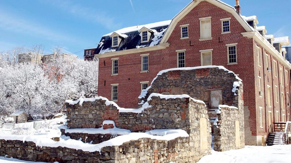 The outside of the Luckenbach Mill and the Dye House covered in snow