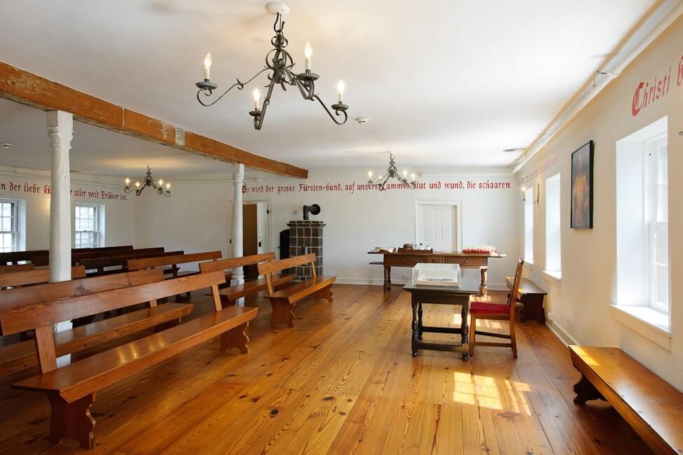 Interior of Moravian Museum. The Saal is pictured with wooden pews and wooden floors.
